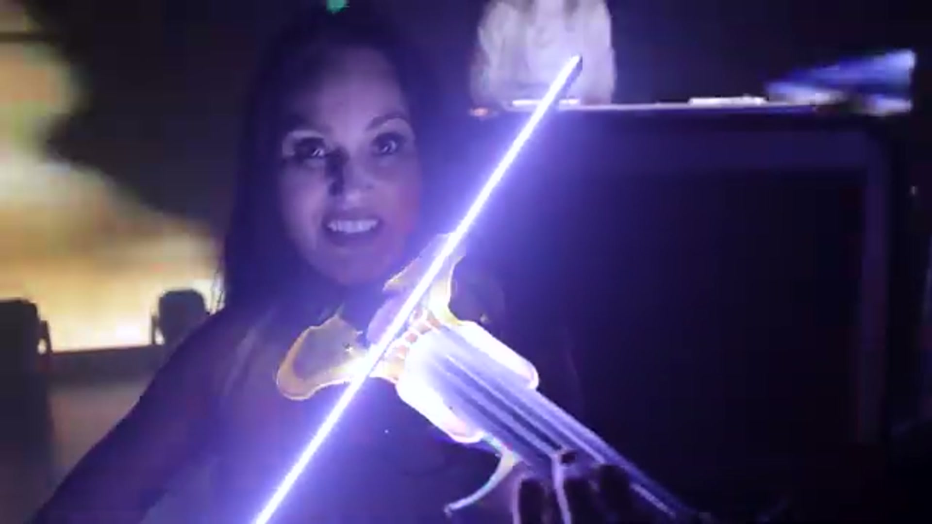 A VYNILYN light up violin show: an illuminated LED bow and custom light up violin on a dark stage