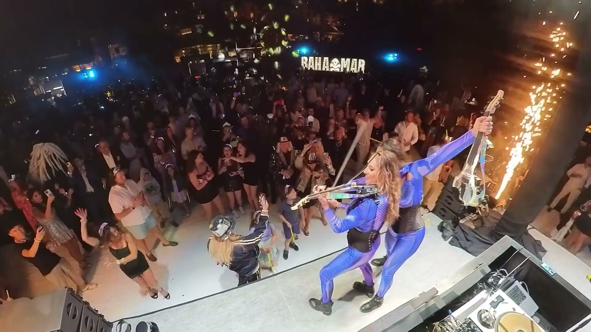 Corporate event entertainment: VYNILYN performing to a packed crowd under stage lighting